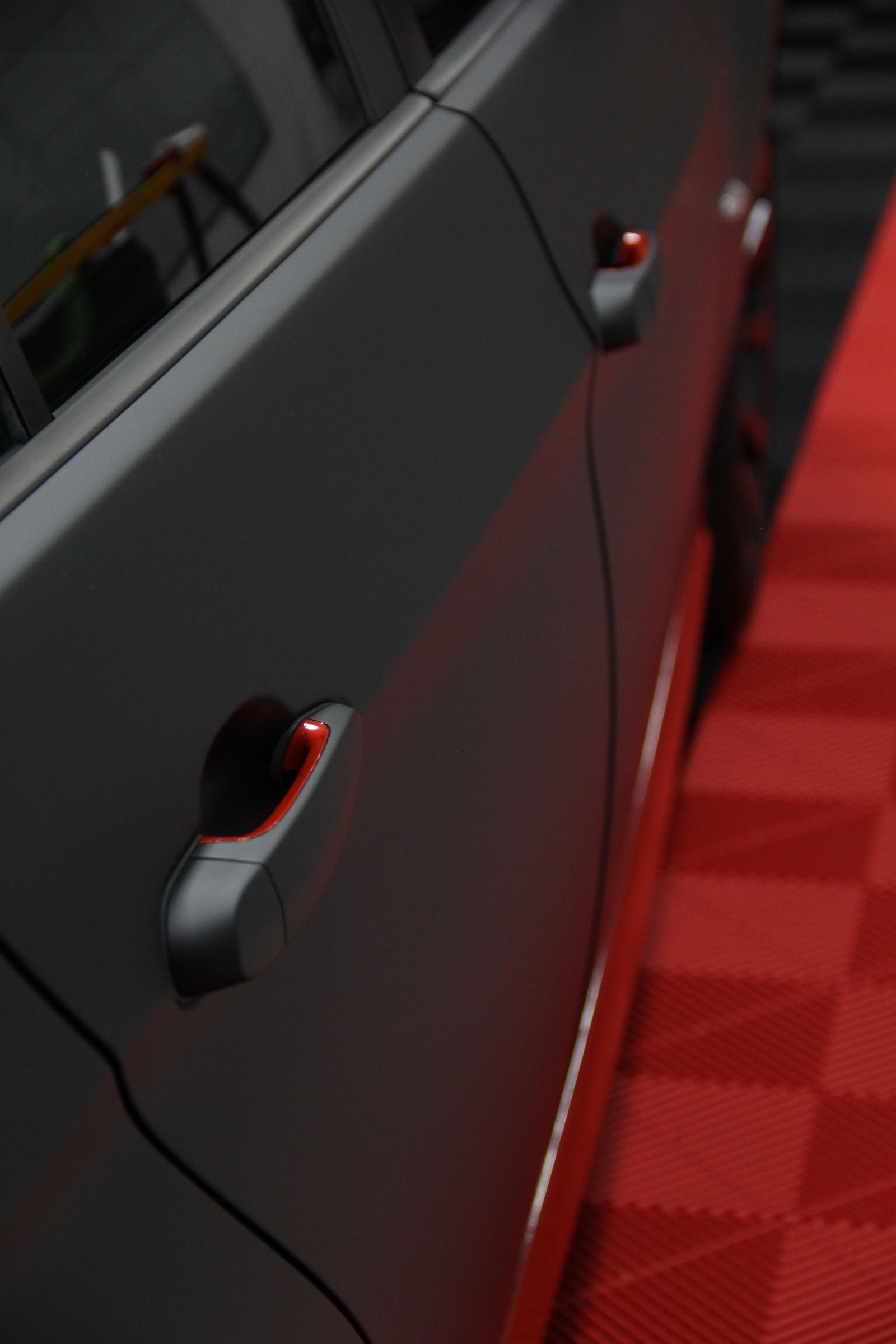 Matte black vinyl wrap with gloss red accents